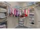 Walk-in closet featuring ample storage with shelves and hanging rods for organized clothing at 308 Planters Way, Mount Holly, NC 28120