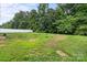 A spacious and grassy backyard featuring a white fence line and a treeline at 3124 Pikes Peak Dr, Gastonia, NC 28052