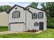 Charming two-story home with a white exterior, black accents, and freshly landscaped front yard at 3124 Pikes Peak Dr, Gastonia, NC 28052