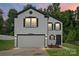 Charming two-story home featuring a gray exterior, black accents, and well-maintained landscaping at 3124 Pikes Peak Dr, Gastonia, NC 28052