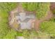 Aerial view of a charming home nestled among lush trees, showcasing its private setting and meticulously landscaped yard at 3318 Providence Hills Dr, Matthews, NC 28105