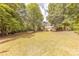 Expansive backyard with manicured lawn and mature trees, offering ample space for outdoor activities and relaxation at 3318 Providence Hills Dr, Matthews, NC 28105