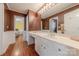 Spacious bathroom with a large mirror, wood floors, and white wainscotting with neutral paint above at 3318 Providence Hills Dr, Matthews, NC 28105