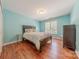 Charming bedroom with wood floors, natural light, and neutral paint at 3318 Providence Hills Dr, Matthews, NC 28105