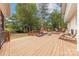 Spacious wooden deck with outdoor furniture, including lounge chairs and a seating area, overlooks the backyard at 3318 Providence Hills Dr, Matthews, NC 28105