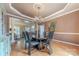 Formal dining room with hardwood floors, modern chandelier, and space for hosting memorable gatherings at 3318 Providence Hills Dr, Matthews, NC 28105