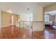Upstairs hallway with hardwood flooring and views into the bedrooms, with natural light at 3318 Providence Hills Dr, Matthews, NC 28105