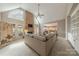 Bright living room with stone fireplace, high ceilings, and open access to the kitchen, ideal for modern living and entertaining at 3318 Providence Hills Dr, Matthews, NC 28105