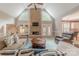 Spacious living room with a stone fireplace, cathedral ceiling, and comfortable seating ideal for relaxing or entertaining friends at 3318 Providence Hills Dr, Matthews, NC 28105