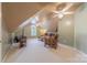 Attic living room with neutral carpet, vaulted ceilings and multiple ceiling fans at 3318 Providence Hills Dr, Matthews, NC 28105