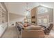 Inviting living room with vaulted ceilings, a stone fireplace, and an open layout perfect for relaxation and entertaining guests at 3318 Providence Hills Dr, Matthews, NC 28105