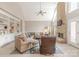 Vaulted living room with a stone fireplace, built-in shelving, and abundant natural light creating a warm and inviting atmosphere at 3318 Providence Hills Dr, Matthews, NC 28105