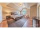 Bright main bedroom features hardwood floors, tray ceilings, and a large window at 3318 Providence Hills Dr, Matthews, NC 28105