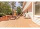 Spacious wooden patio with outdoor seating and views of the large backyard and wooded area at 3318 Providence Hills Dr, Matthews, NC 28105
