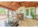 Well-appointed screened porch with wood ceiling, bar, and comfortable seating at 3318 Providence Hills Dr, Matthews, NC 28105