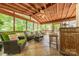 Relaxing screened in porch with tile flooring, comfortable seating, and views of the outdoors at 3318 Providence Hills Dr, Matthews, NC 28105