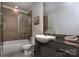 Well-lit bathroom featuring modern fixtures, a walk-in shower, a large mirror, a toilet, and granite countertops at 333 W Trade St # 1304, Charlotte, NC 28202
