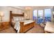 Bedroom featuring a large window with city views, a spacious bed, and side tables at 333 W Trade St # 1304, Charlotte, NC 28202