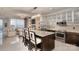 Bright kitchen boasts an island with bar seating, stainless appliances, and a view into the living area at 333 W Trade St # 1304, Charlotte, NC 28202