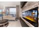 Cozy living room with a stone accent wall, a sleek fireplace, and a large window showcasing city views at 333 W Trade St # 1304, Charlotte, NC 28202