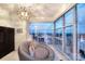 Relaxing sitting area with a unique chair, modern lighting, and expansive city views through large windows at 333 W Trade St # 1304, Charlotte, NC 28202