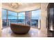 Inviting sitting area with modern lighting and furniture, showcasing panoramic city views through expansive windows at 333 W Trade St # 1304, Charlotte, NC 28202