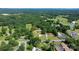A wide aerial shot displays residences and businesses surrounded by trees, roads, and open fields at 3423 S Hwy 127 Hwy, Hickory, NC 28602