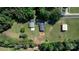 Aerial view showcases a home with spacious yard, outbuildings, and surrounding trees at 3423 S Hwy 127 Hwy, Hickory, NC 28602