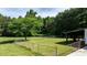 Fenced backyard with green grass and a covered patio next to the house at 3423 S Hwy 127 Hwy, Hickory, NC 28602
