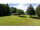 Expansive backyard featuring lush green lawn and mature trees surrounding a home with a partially fenced yard at 3423 S Hwy 127 Hwy, Hickory, NC 28602