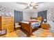 Cozy bedroom with floral wallpaper, hardwood floors, and a wooden bed frame at 3423 S Hwy 127 Hwy, Hickory, NC 28602