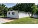 Exterior of house with white siding and a green roof, with a concrete patio area and an above-ground pool at 3423 S Hwy 127 Hwy, Hickory, NC 28602