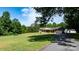 Well-maintained brick home with a charming covered porch, complemented by green lawns and mature trees at 3423 S Hwy 127 Hwy, Hickory, NC 28602