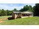 Brick home offers a covered porch, attached garage, and sizable lawn, promising comfortable living at 3423 S Hwy 127 Hwy, Hickory, NC 28602