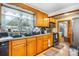 Cozy kitchen with wood cabinets, black appliances, and a window over the sink for natural light at 3423 S Hwy 127 Hwy, Hickory, NC 28602