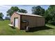 Spacious outbuilding with large roll-up door on a well-maintained lawn and mature trees on the property at 3423 S Hwy 127 Hwy, Hickory, NC 28602