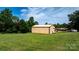 Large outbuilding is adjacent to the home, with a garage door and a well-manicured lawn at 3423 S Hwy 127 Hwy, Hickory, NC 28602