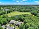 Expansive aerial view of a golf course community with houses and lush green landscape at 35115 Carnation Ln, Fort Mill, SC 29707