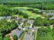 Aerial view of beautiful homes nestled in a lush, green golf course community with a pond at 35115 Carnation Ln, Fort Mill, SC 29707