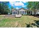 Large backyard featuring brick retaining wall, patio, and lush green lawn on a sunny day at 35115 Carnation Ln, Fort Mill, SC 29707