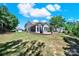 Exterior home view showing a well-maintained yard, brick patio, and lush greenery at 35115 Carnation Ln, Fort Mill, SC 29707