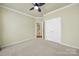 This bedroom includes neutral paint and carpet, a ceiling fan, and a double-door closet at 35115 Carnation Ln, Fort Mill, SC 29707