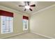 This bedroom includes neutral paint and carpet and a large window at 35115 Carnation Ln, Fort Mill, SC 29707