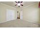 This bedroom features neutral paint and carpet, crown molding, and a ceiling fan at 35115 Carnation Ln, Fort Mill, SC 29707