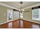 Bright dining room featuring hardwood floors, chandelier, and access to the outdoor patio at 35115 Carnation Ln, Fort Mill, SC 29707