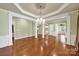 Elegant dining room with hardwood floors, decorative columns, and chandelier at 35115 Carnation Ln, Fort Mill, SC 29707