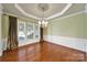 Formal dining room showcasing large windows, wainscoting, and a chandelier at 35115 Carnation Ln, Fort Mill, SC 29707