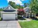 Charming home boasts manicured lawn, stone accents, and a two-car garage at 35115 Carnation Ln, Fort Mill, SC 29707