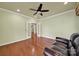 Comfortable living room featuring hardwood floors, natural light, and modern ceiling fan at 35115 Carnation Ln, Fort Mill, SC 29707