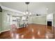 Open concept living room featuring hardwood floors, kitchen bar, and a fireplace, perfect for entertaining at 35115 Carnation Ln, Fort Mill, SC 29707